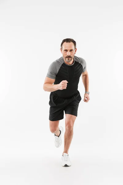 Handsome serious mature sportsman running isolated — Stock Photo, Image