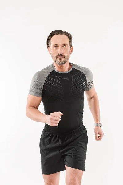 Portrait of focused motivated adult man 30s wearing sportswear h — Stock Photo, Image