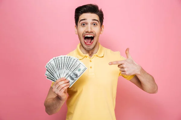 Portrait of an excited young man pointing finger — Stock Photo, Image