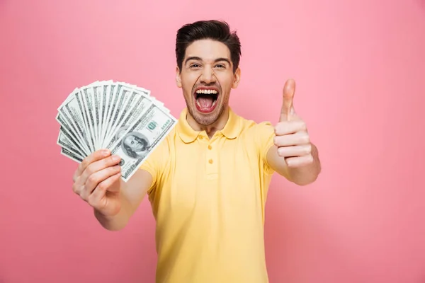 Portrait of a cheerful young man holding money banknotes — Stock Photo, Image