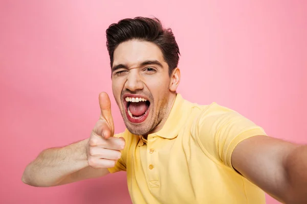 Porträt eines glücklichen jungen Mannes, der mit dem Finger zeigt — Stockfoto