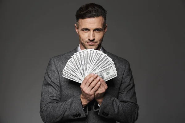 Photo of confident guy 30s in business suit holding fan of money — Stock Photo, Image