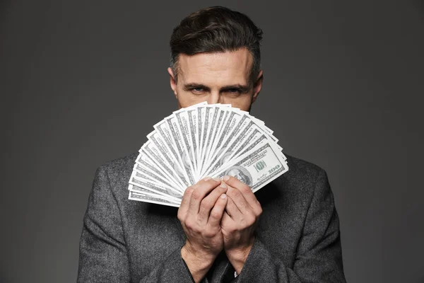 Photo of confident guy 30s in business suit holding fan of money — Stock Photo, Image