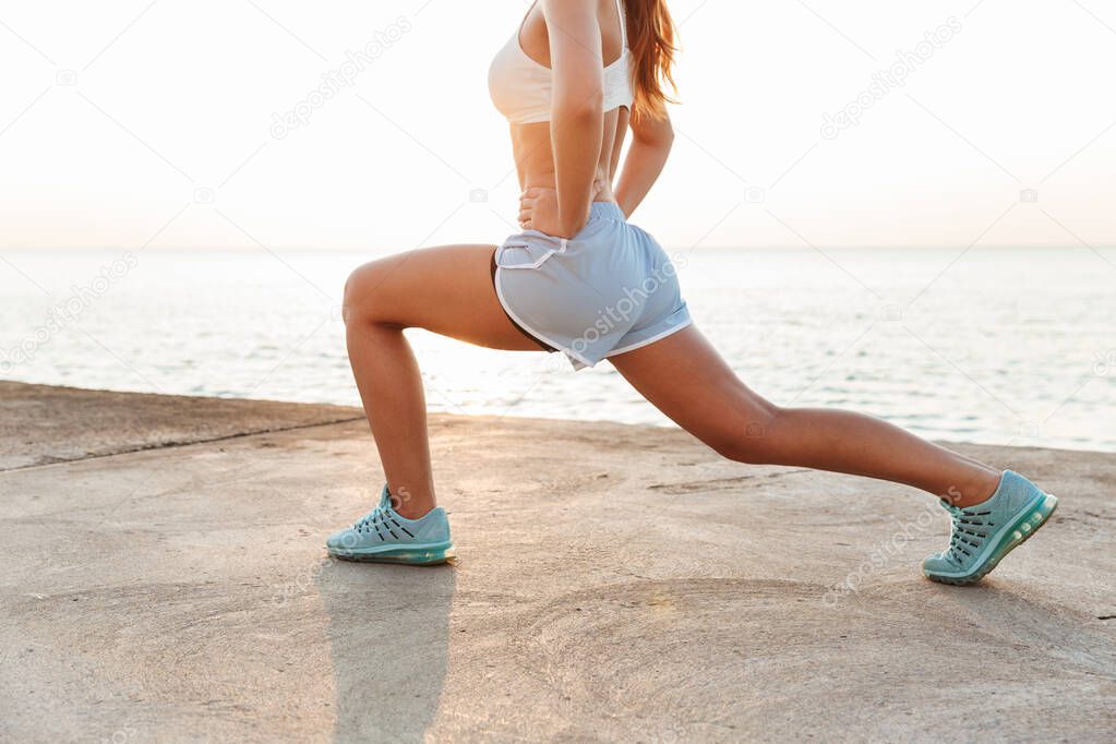 Cropped image of energetic caucasian woman in sportswear doing w