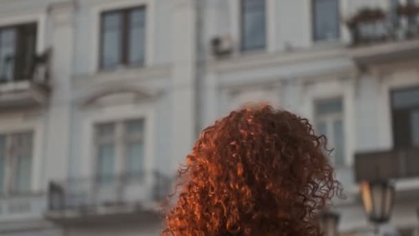 Excited Beautiful Young Redhead Curly Woman Smiling Spinning While Walking — Stockvideo