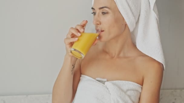 Cheerful Thoughtful Young Woman Wearing White Towel Bath Drinking Orange — Stock Video