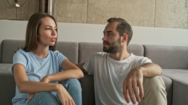 Attraente Giovane Bella Coppia Sorridente Parlando Mentre Seduto Sul Pavimento — Video Stock