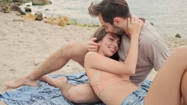 Handsome Calm Young Bearded Man Hugging His Cute Young Girlfriend — Stock Video