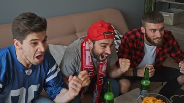 Three Cheerful Men Fans Rejoicing Screaming While Watching Sport Apartment — Stock Video