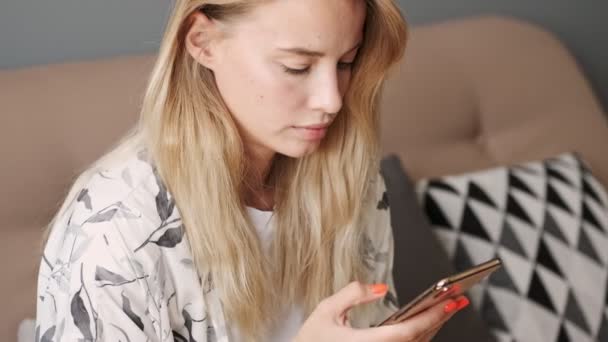 Beauty Calm Blonde Woman Using Smartphone While Sitting Sofa Home — Stock Video