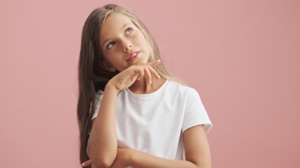 Pensive Little Girl Wearing White Shirt Thinking Pink Background Isolated — Stock Video