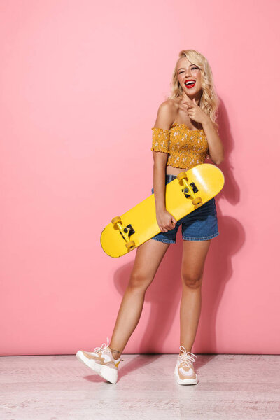 Full length image of content young woman with red lipstick weari