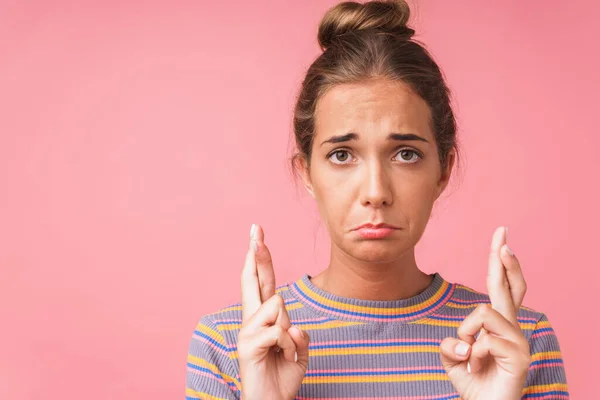 Image closeup of unhappy caucasian woman wearing striped t-shirt looking at camera with fingers crossed — Stock Photo, Image