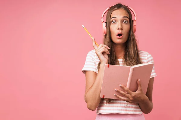 Image of surprised beautiful girl writing down notes at diary bo — Stock Photo, Image