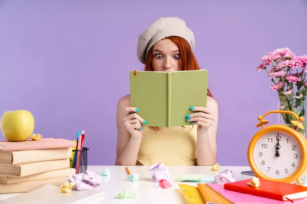 Photo of confused student girl holding exercise book while doing