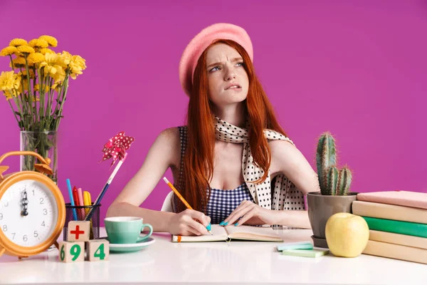 Imagen de una adolescente tensa estudiando con libros de ejercicios mientras está sentada en el escritorio — Foto de Stock