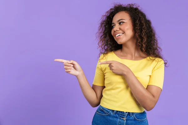 Imagem da mulher americana africana satisfeita apontando os dedos para o copyspace com sorriso — Fotografia de Stock