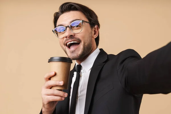 Imagem de um empresário feliz segurando xícara de café enquanto toma selfi — Fotografia de Stock