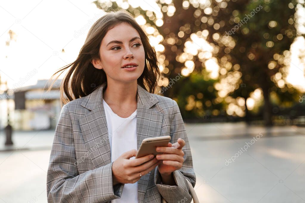 Attractive stylish young girl using mobile phone