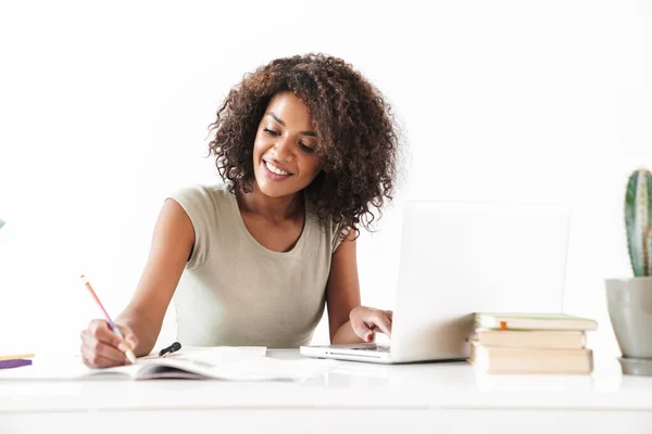 Attractive young african woman working with laptop computer — Stock Photo, Image