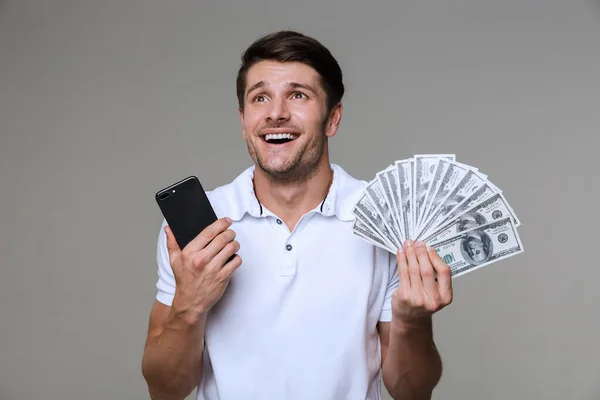 Positive young man holding money. — Stock Photo, Image