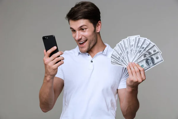 Positive young man holding money. — Stock Photo, Image