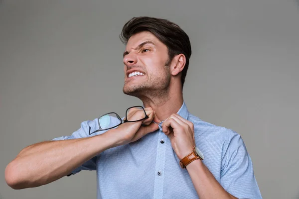 Business man try to take off his shirt holding eyeglasses — Stock Photo, Image