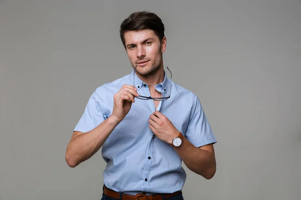 Handsome business man take off his shirt holding eyeglasses. — Stock Photo, Image