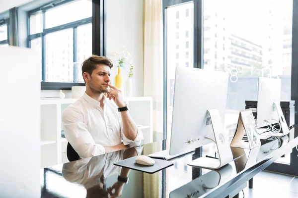 Immagine di uomo d'affari concentrato seduto a tavola e al lavoro o — Foto Stock