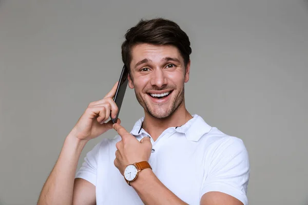 Joven guapo alegre hablando por teléfono móvil . — Foto de Stock