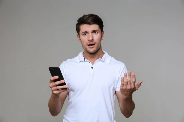 Joven confuso posando aislado — Foto de Stock