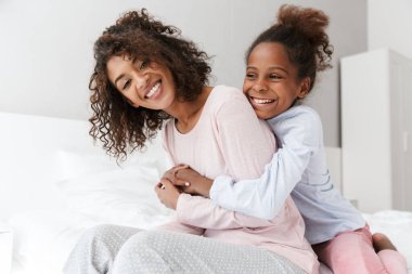 Afro-Amerikan kadın ve küçük kızının kucaklaşması. 