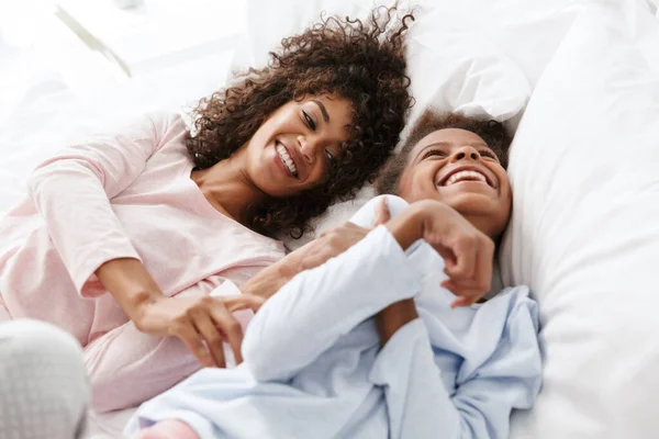 stock image Image of cheerful african american woman and her daughter lying 