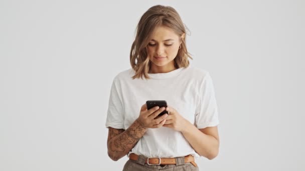 Optimistic Happy Young Woman Wearing White Basic Shirt Using Her — Stockvideo