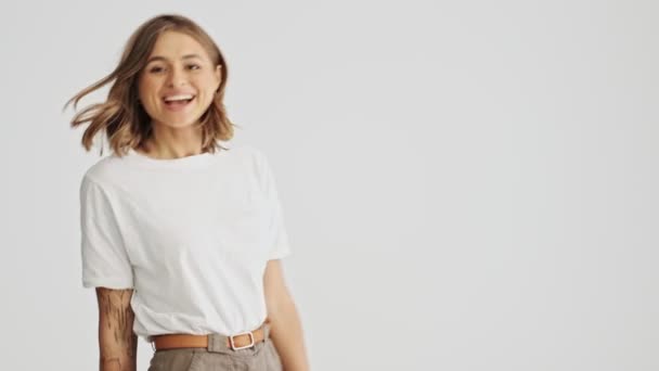 Glimlachende Jonge Vrouw Draagt Basic Shirt Komt Dan Recht Haar — Stockvideo