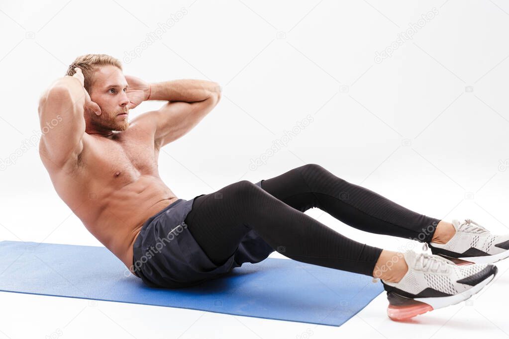 Confident attractive sportsman doing core exercise