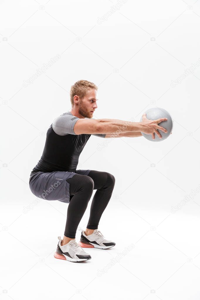 Confident handsome young fit sportsman doing exercises