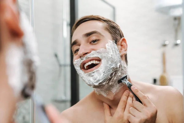 有魅力的年轻赤身裸体男人刮胡子 — 图库照片