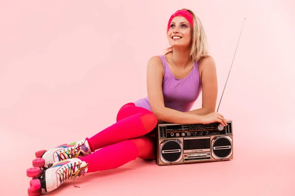 Image of smiling pretty woman using tape-player while sitting on floor — Stock Photo, Image