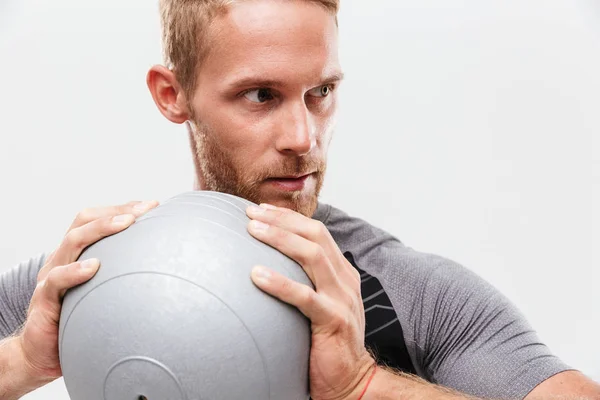 Confident handsome young fit sportsman doing exercises — Stock Photo, Image