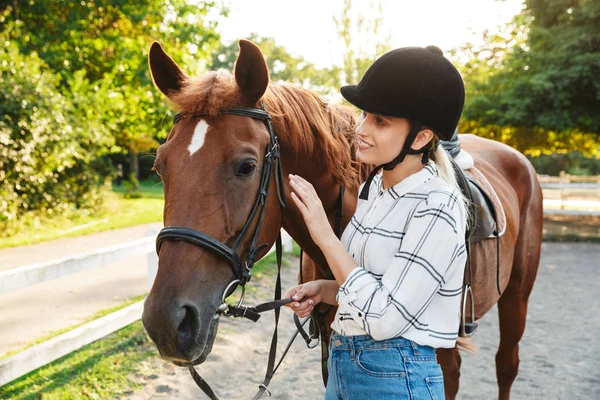 Imagen de la mujer bonita con sombrero de pie a caballo en el patio en c — Foto de Stock