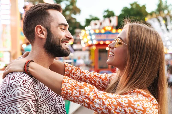 Loving couple walking outdoors in amusement park — Stock Photo, Image