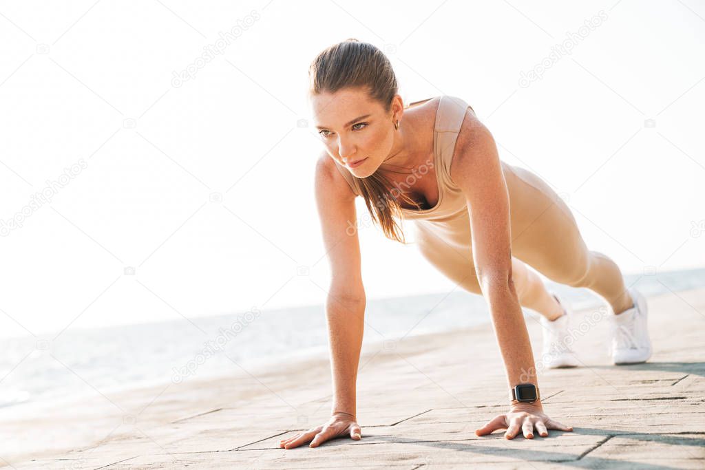 Fitness woman outdoors on beach make yoga sport exercise.