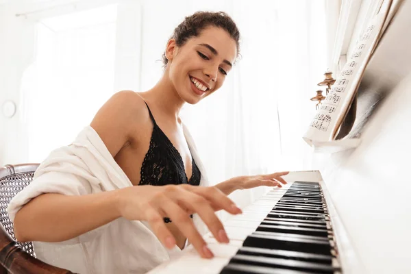 Senhora em lingerie e camisa branca tocar piano — Fotografia de Stock