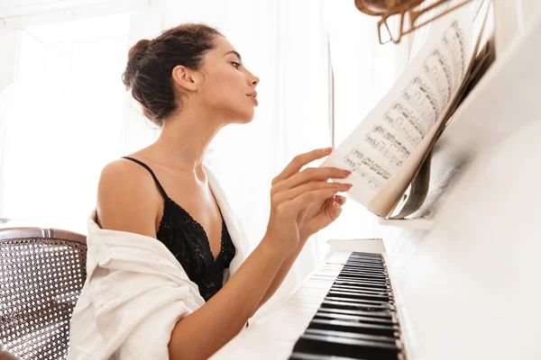 Senhora em lingerie e camisa branca tocar piano — Fotografia de Stock