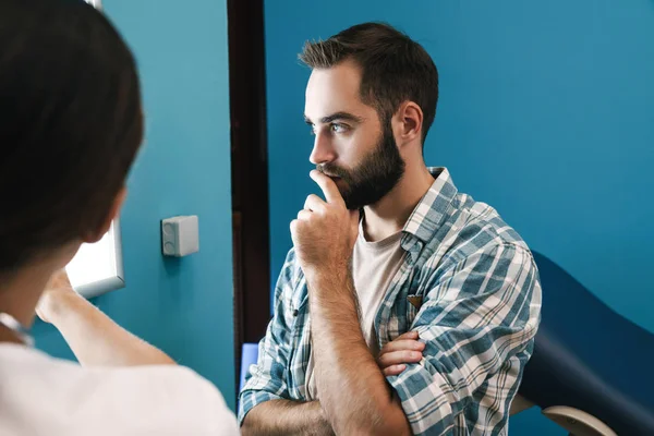 Image of female doctor and patient man looking at x-ray scan in — Stock Photo, Image