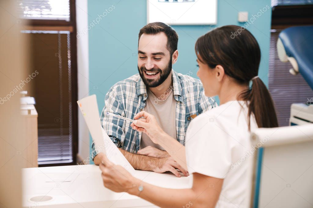 Image of female doctor and patient man looking at health results