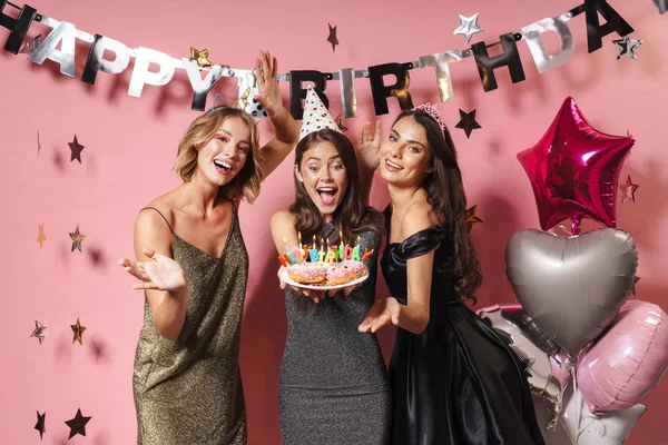 Image of beautiful party girls holding birthday cake with candle — ストック写真