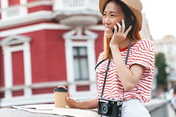 Vacker asiatisk kvinna som går utomhus och pratar per telefon. — Stockfoto