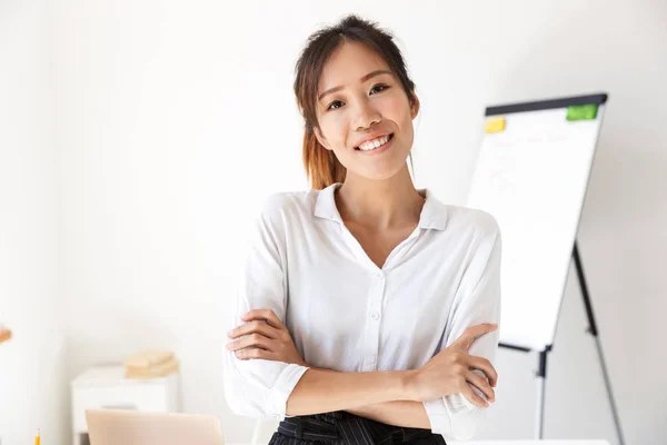 Confiado atractivo joven asiático mujer de negocios de pie en su oficina —  Fotos de Stock